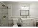 Well-lit bathroom with a marble tiled shower, a decorative mirror, and a white vanity sink at 3933 Edgemoor Way, Las Vegas, NV 89121