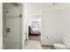 A bathroom with a shower and toilet, leading to the bedroom at 3933 Edgemoor Way, Las Vegas, NV 89121