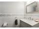 Clean powder room featuring a gray vanity, modern faucet, and tiled backsplash at 3933 Edgemoor Way, Las Vegas, NV 89121