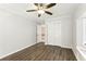 Bedroom featuring a ceiling fan, closet, and wood-look floors at 3933 Edgemoor Way, Las Vegas, NV 89121