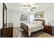 Bedroom with a comfortable bed, wood-look floors, a ceiling fan, and natural light at 3933 Edgemoor Way, Las Vegas, NV 89121