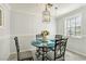 Cozy dining room with a glass table, wrought iron chairs, and stylish lighting at 3933 Edgemoor Way, Las Vegas, NV 89121