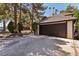 Spacious two-car garage attached to a home with lush landscaping and a driveway at 3933 Edgemoor Way, Las Vegas, NV 89121