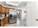 Kitchen with stainless steel appliances, wood cabinets, and tile flooring at 3933 Edgemoor Way, Las Vegas, NV 89121