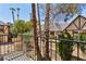 Balcony view showcasing palm trees and neighborhood architecture under a bright blue sky at 3933 Edgemoor Way, Las Vegas, NV 89121