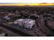 Aerial view of a modern house under construction with a stunning city vista at sunset at 7090 Fazio Dr, Las Vegas, NV 89110