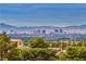 Daytime aerial view showcasing Las Vegas skyline and mountain backdrop at 7090 Fazio Dr, Las Vegas, NV 89110