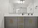 Bathroom with gray vanity, white countertop, and gold accents at 3784 Pama Ln, Las Vegas, NV 89120
