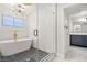 Modern bathroom with hexagon tile floor, freestanding tub, and walk-in shower at 3784 Pama Ln, Las Vegas, NV 89120