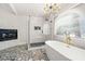 Bathroom with a walk-in shower, freestanding tub and patterned floor at 3784 Pama Ln, Las Vegas, NV 89120