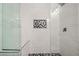 Shower with white and black hexagon tile and glass enclosure at 3784 Pama Ln, Las Vegas, NV 89120