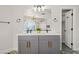 Double vanity bathroom with gray cabinets and gold hardware at 3784 Pama Ln, Las Vegas, NV 89120