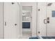 Modern bathroom with a walk-in shower, blue vanity, and hexagon tile floor at 3784 Pama Ln, Las Vegas, NV 89120