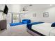 Main bedroom with blue accents and sliding doors to a patio at 3784 Pama Ln, Las Vegas, NV 89120