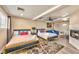 Spacious bedroom with two beds, a fireplace, and a sitting area at 3784 Pama Ln, Las Vegas, NV 89120