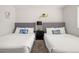 Two twin beds with gray headboards, nightstands, and blue pillows at 3784 Pama Ln, Las Vegas, NV 89120