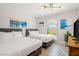 Two twin beds with gray headboards, artwork, and natural light at 3784 Pama Ln, Las Vegas, NV 89120