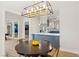 Dining area with modern chandelier and kitchen views at 3784 Pama Ln, Las Vegas, NV 89120