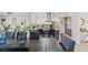 Modern dining room with a large dark wood table and blue glass vases at 3784 Pama Ln, Las Vegas, NV 89120