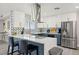Updated kitchen featuring white and blue cabinets, quartz countertops, and a stainless steel range hood at 3784 Pama Ln, Las Vegas, NV 89120