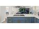 Modern kitchen with blue cabinetry, quartz countertops and stainless steel appliances at 3784 Pama Ln, Las Vegas, NV 89120