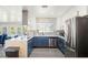 Modern kitchen with white and blue cabinets, quartz countertops and stainless steel appliances at 3784 Pama Ln, Las Vegas, NV 89120