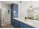Modern kitchen with blue cabinets, white countertops, and stainless steel appliances at 3784 Pama Ln, Las Vegas, NV 89120