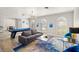 Spacious living room with gray sofa, blue accents, and a pool table at 3784 Pama Ln, Las Vegas, NV 89120