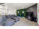 Spacious living room featuring sectional sofa and a green accent wall at 3784 Pama Ln, Las Vegas, NV 89120