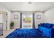 Cozy sitting area with blue sofa, plush rug, and sliding glass doors to the pool at 3784 Pama Ln, Las Vegas, NV 89120