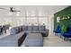 Living room with sectional sofa, ottoman, and view into dining area at 3784 Pama Ln, Las Vegas, NV 89120