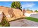 A fenced backyard features a small patio, a patch of artificial grass, and some landscaping at 9333 Leaping Deer Pl # 102, Las Vegas, NV 89178