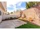 A fenced backyard features a small patio, a patch of artificial grass, and some landscaping at 9333 Leaping Deer Pl # 102, Las Vegas, NV 89178