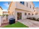 A townhouse backyard has a small patio, artificial grass, and a slider that leads inside at 9333 Leaping Deer Pl # 102, Las Vegas, NV 89178