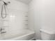 Bright bathroom featuring white tub, shower with tiled walls and a toilet at 9333 Leaping Deer Pl # 102, Las Vegas, NV 89178