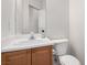 Bathroom with a single vanity, wood cabinets, mirror and a toilet at 9333 Leaping Deer Pl # 102, Las Vegas, NV 89178
