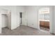 Spacious bedroom featuring neutral walls and carpet, with closet and bathroom door at 9333 Leaping Deer Pl # 102, Las Vegas, NV 89178
