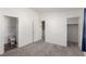A spacious bedroom with neutral carpet leads to a bathroom and a closet with ample space at 9333 Leaping Deer Pl # 102, Las Vegas, NV 89178