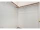 A simple closet design features a wooden rod for hanging clothes and neutral paint at 9333 Leaping Deer Pl # 102, Las Vegas, NV 89178