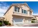 Townhome exterior with attached garages and well-maintained landscaping at 9333 Leaping Deer Pl # 102, Las Vegas, NV 89178