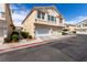 Inviting two-story townhome with a multi-car garage, well-maintained landscaping, and stucco siding at 9333 Leaping Deer Pl # 102, Las Vegas, NV 89178