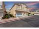 Inviting two-story townhome with a multi-car garage, well-maintained landscaping, and stucco siding at 9333 Leaping Deer Pl # 102, Las Vegas, NV 89178