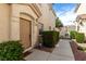 Inviting front entry featuring a well-manicured yard with green bushes and a concrete walkway at 9333 Leaping Deer Pl # 102, Las Vegas, NV 89178