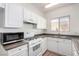 Clean and bright kitchen featuring modern appliances, white cabinetry, and neutral countertops at 9333 Leaping Deer Pl # 102, Las Vegas, NV 89178