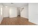 Spacious living area with sleek wood flooring, neutral walls, and ample room for customization at 9333 Leaping Deer Pl # 102, Las Vegas, NV 89178