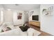 Bright living room with modern furnishings, wood flooring, and stylish decor for a cozy atmosphere at 9333 Leaping Deer Pl # 102, Las Vegas, NV 89178