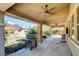 Spacious back patio features an outdoor kitchen, ceiling fans, and overlooks the lush backyard with a pool and waterfall at 5301 Fairbranch Ln, Las Vegas, NV 89135