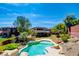 An aerial view of the backyard featuring a lagoon-style pool, landscaping, and partial view of the two-story home at 5301 Fairbranch Ln, Las Vegas, NV 89135
