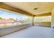 Large, covered balcony featuring neighborhood views and neutral stucco walls at 5301 Fairbranch Ln, Las Vegas, NV 89135