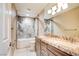 Bathroom featuring double sinks, granite counters, and shower with decorative surround at 5301 Fairbranch Ln, Las Vegas, NV 89135